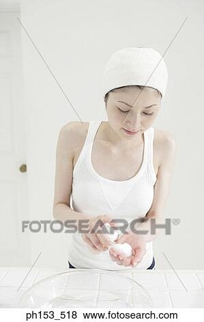 Close-up of a young woman pouring moisturizer on a cotton ball View Large Photo Image Stock Photo - Close-up of a young woman pouring moisturizer on a cotton ball. Fotosearch