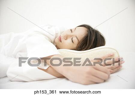 Close-up of a young woman sleeping on the bed View Large Photo Image Stock Image - Close-up of a young woman sleeping on the bed. Fotosearch