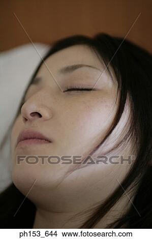 Picture - Close-up of a young woman sleeping. Fotosearch