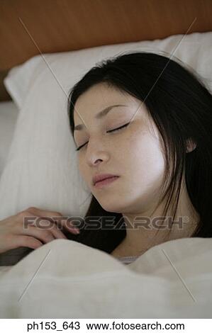 Close-up of a young woman sleeping View Large Photo Image Stock Image - Close-up of a young woman sleeping. Fotosearch
