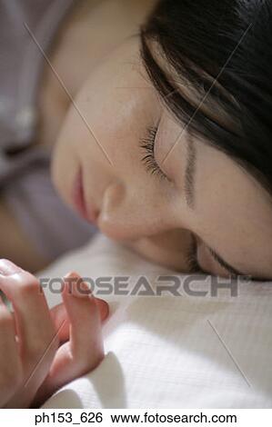 Stock Photograph - Close-up of a young woman sleeping. Fotosearch