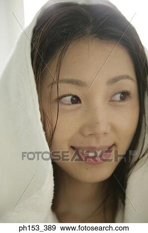 Close-up of a young woman smiling View Large Photo Image Stock Photo - Close-up of a young woman smiling. Fotosearch