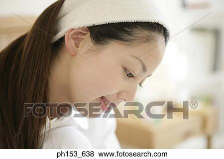 Close-up of a young woman smiling View Large Photo Image Stock Photo - Close-up of a young woman smiling. Fotosearch