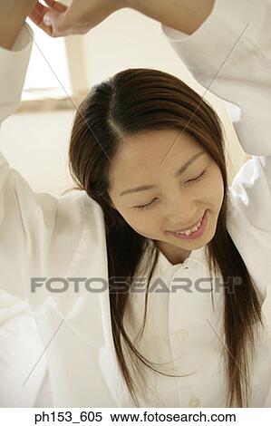 Stock Photography - Close-up of a young woman stretching her arms. Fotosearch