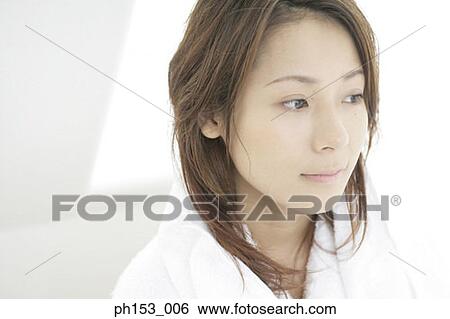 Close-up of a young woman thinking View Large Photo Image Stock Photograph - Close-up of a young woman thinking. Fotosearch