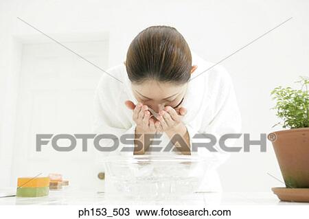 Close-up of a young woman washing her face View Large Photo Image Stock Image - Close-up of a young woman washing her face. Fotosearch