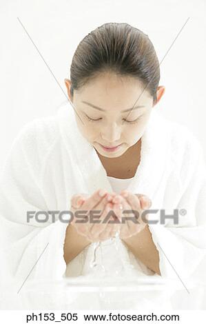 Close-up of a young woman washing her face View Large Photo Image Stock Photography - Close-up of a young woman washing her face. Fotosearch