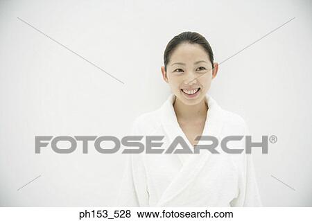 Close-up of a young woman wearing a bathrobe and smiling View Large Photo Image Stock Photo - Close-up of a young woman wearing a bathrobe and smiling. Fotosearch