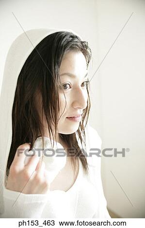 Close-up of a young woman wiping face with washcloth View Large Photo Image Stock Image - Close-up of a young woman wiping face with washcloth. Fotosearch