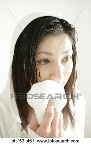 Close-up of a young woman wiping her face with a washcloth View Large Photo Image Stock Image - Close-up of a young woman wiping her face with a washcloth. Fotosearch