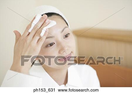Close-up of a young woman wiping her face with a handkerchief View Large Photo Image Stock Image - Close-up of a young woman wiping her face with a handkerchief. Fotosearch