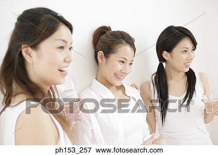 Close-up of three young women smiling View Large Photo Image Stock Photo - Close-up of three young women smiling. Fotosearch