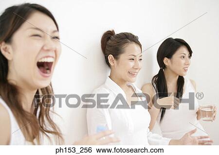 Close-up of three young women smiling View Large Photo Image Stock Photograph - Close-up of three young women smiling. Fotosearch