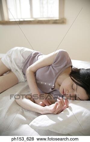 High angle view of a young woman sleeping View Large Photo Image Stock Photo - High angle view of a young woman sleeping. Fotosearch