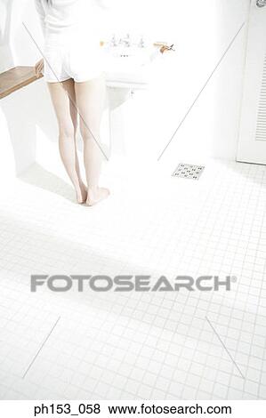 Low section view of a woman standing in front of a bathroom sink View Large Photo Image Stock Photo - Low section view of a woman standing in front of a bathroom sink. Fotosearch