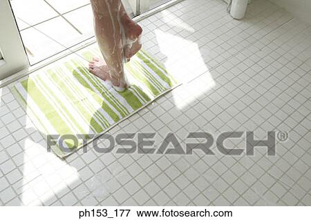 Low section view of a woman's feet on a bathroom floor View Large Photo Image Stock Photo - Low section view of a woman's feet on a bathroom floor. Fotosearch