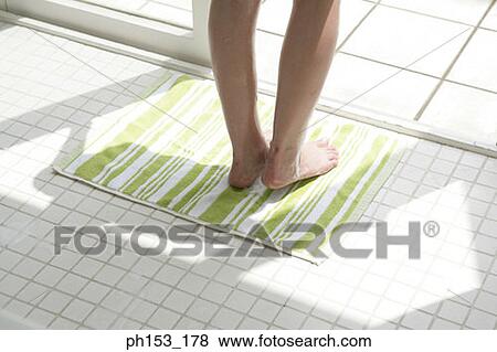 Low section view of a woman's feet on a bathroom floor View Large Photo Image Stock Photo - Low section view of a woman's feet on a bathroom floor. Fotosearch