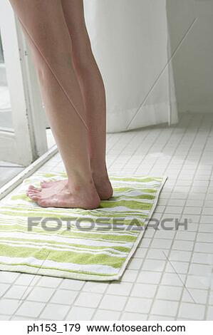 Low section view of a woman's feet on a bathroom floor View Large Photo Image Stock Photo - Low section view of a woman's feet on a bathroom floor. Fotosearch