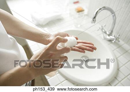 Mid section view of a man spraying soap on the palm of his hand View Large Photo Image Stock Photo - Mid section view of a man spraying soap on the palm of his hand. Fotosearch