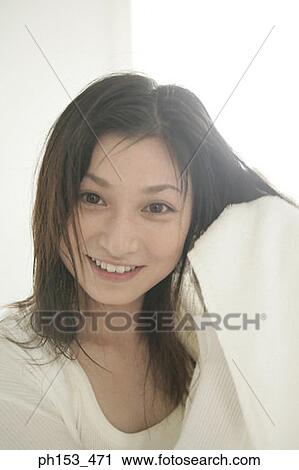 Portrait of a young woman drying her hair with a towel View Large Photo Image Stock Image - Portrait of a young woman drying her hair with a towel. Fotosearch