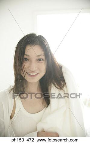 Portrait of a young woman drying her hair with a towel View Large Photo Image Stock Image - Portrait of a young woman drying her hair with a towel. Fotosearch