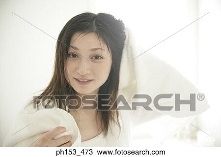 Portrait of a young woman drying her hair with a towel View Large Photo Image Stock Image - Portrait of a young woman drying her hair with a towel. Fotosearch
