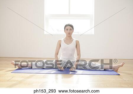 Portrait of a young woman sitting with her legs apart View Large Photo Image Stock Image - Portrait of a young woman sitting with her legs apart. Fotosearch