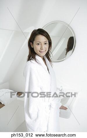 Portrait of a young woman standing near a bathroom sink View Large Photo Image Stock Image - Portrait of a young woman standing near a bathroom sink. Fotosearch