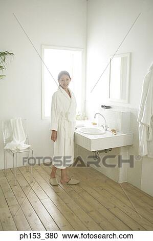 Portrait of a young woman standing near a bathroom sink and smiling View Large Photo Image Stock Image - Portrait of a young woman standing near a bathroom sink and smiling. Fotosearch