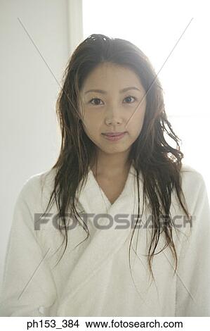 Portrait of a young woman wearing a bathrobe View Large Photo Image Picture - Portrait of a young woman wearing a bathrobe. Fotosearch