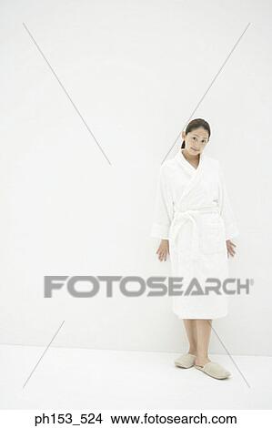 Portrait of a young woman wearing a bathrobe View Large Photo Image Picture - Portrait of a young woman wearing a bathrobe. Fotosearch