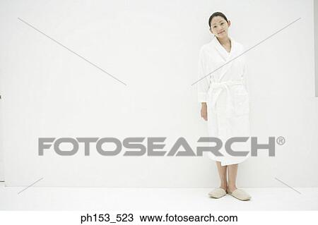 Portrait of a young woman wearing a bathrobe View Large Photo Image Stock Image - Portrait of a young woman wearing a bathrobe. Fotosearch
