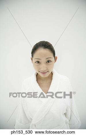 Portrait of a young woman wearing a bathrobe and smiling View Large Photo Image Stock Image - Portrait of a young woman wearing a bathrobe and smiling. Fotosearch