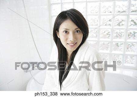 Portrait of a young woman wearing a bathrobe and smiling View Large Photo Image Stock Photo - Portrait of a young woman wearing a bathrobe and smiling. Fotosearch