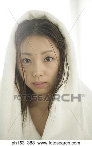 Portrait of a young woman wearing a towel on her head View Large Photo Image Stock Photo - Portrait of a young woman wearing a towel on her head. Fotosearch
