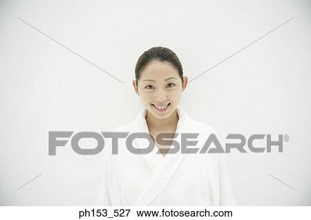 Portrait of a young woman wearing a bathrobe and smiling View Large Photo Image Stock Photo - Portrait of a young woman wearing a bathrobe and smiling. Fotosearch