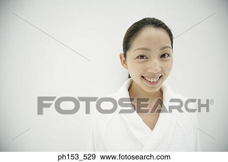 Portrait of a young woman wearing a bathrobe and smiling View Large Photo Image Stock Photo - Portrait of a young woman wearing a bathrobe and smiling. Fotosearch