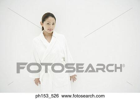 Portrait of a young woman wearing a bathrobe View Large Photo Image Stock Photograph - Portrait of a young woman wearing a bathrobe. Fotosearch
