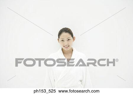 Stock Photography - Portrait of a young woman wearing a bathrobe and smiling. Fotosearch