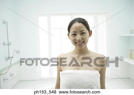Portrait of a young woman wrapped in a towel and smiling View Large Photo Image Stock Photo - Portrait of a young woman wrapped in a towel and smiling. Fotosearch