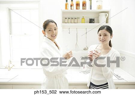 Portrait of two young women in the kitchen View Large Photo Image Stock Image - Portrait of two young women in the kitchen. Fotosearch