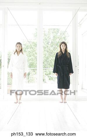 Portrait of two young women standing View Large Photo Image Stock Image - Portrait of two young women standing. Fotosearch