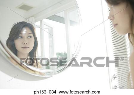 Reflection of a young woman in a mirror View Large Photo Image Picture - Reflection of a young woman in a mirror. Fotosearch