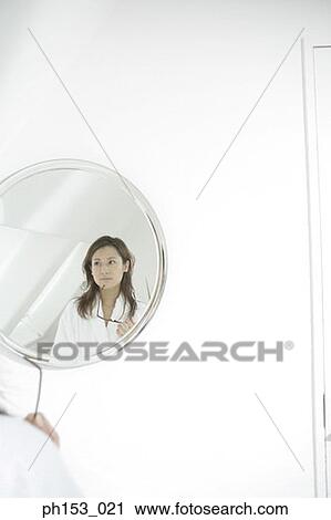 Reflection of a young woman in a mirror holding sunglasses View Large Photo Image Stock Image - Reflection of a young woman in a mirror holding sunglasses. Fotosearch
