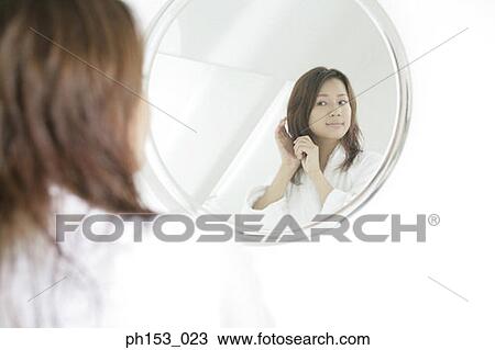 Reflection of a young woman in a mirror View Large Photo Image Stock Image - Reflection of a young woman in a mirror. Fotosearch