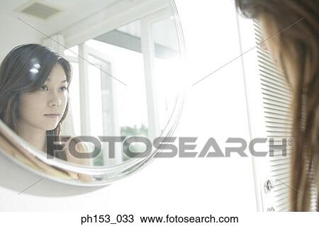 Reflection of a young woman in a mirror View Large Photo Image Stock Image - Reflection of a young woman in a mirror. Fotosearch