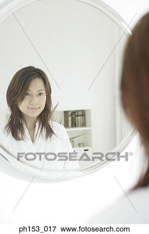 Reflection of a young woman in a mirror View Large Photo Image Stock Photo - Reflection of a young woman in a mirror. Fotosearch