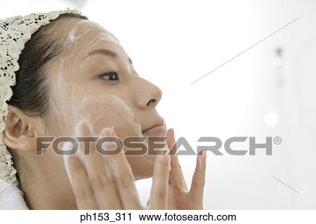 Side profile of a young woman applying soap on her face View Large Photo Image Stock Image - Side profile of a young woman applying soap on her face. Fotosearch