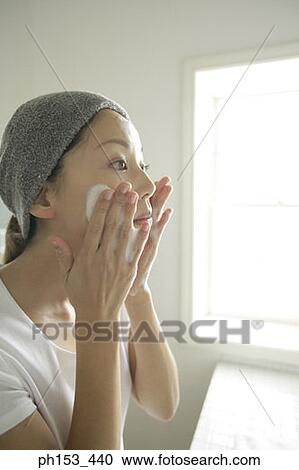 Side profile of a young woman applying soap on her face View Large Photo Image Stock Image - Side profile of a young woman applying soap on her face. Fotosearch