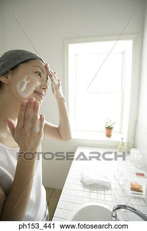 Side profile of a young woman applying soap on her face View Large Photo Image Stock Image - Side profile of a young woman applying soap on her face. Fotosearch